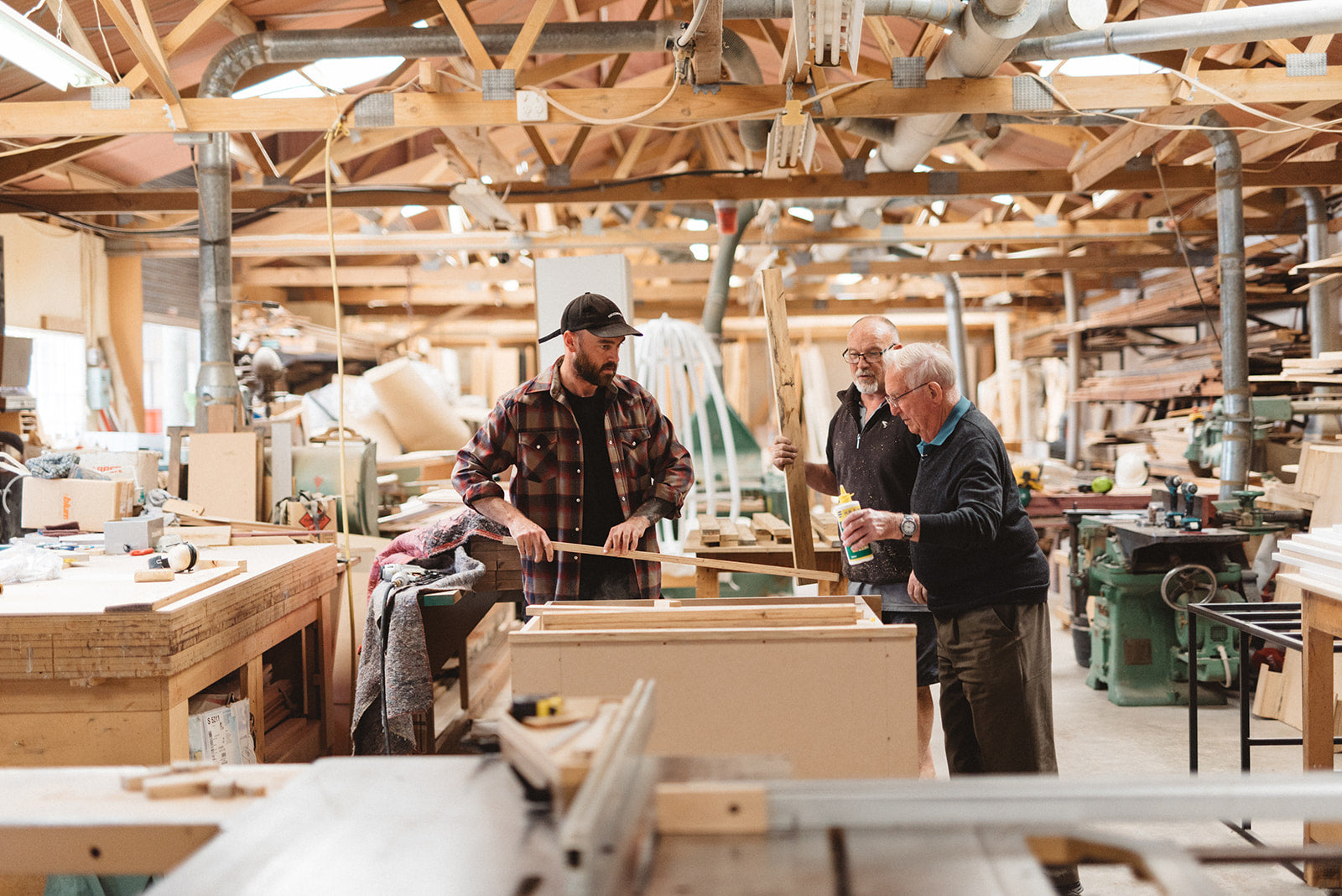Three men in woodworking shop